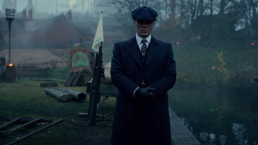 Tommy Shelby in Peaky Blinders Standing in a Misty Industrial Yard HD wallpaper