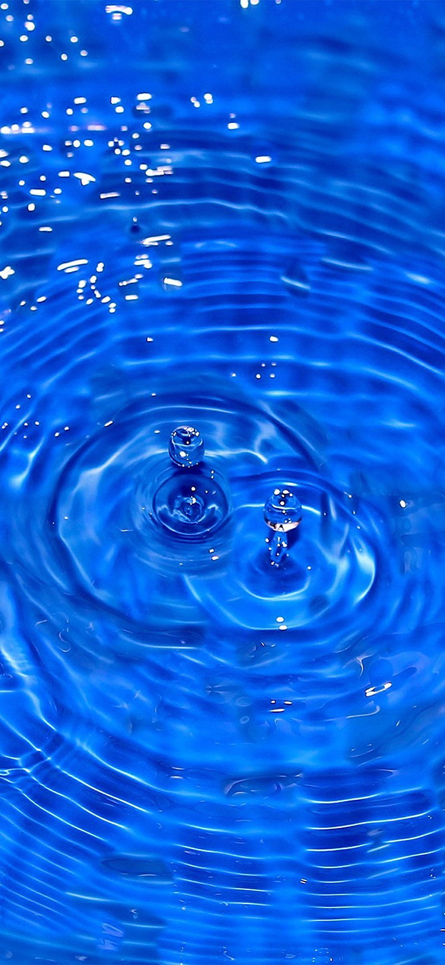 Vibrant Blue Water Ripples with Droplets and Light Reflections HD phone wallpaper