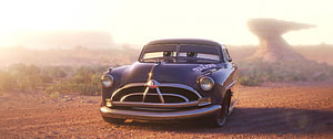 Doc Hudson Hornet from Cars 3 in a Desert Sunset Scene HD wallpaper