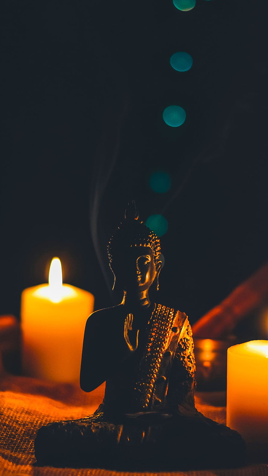 Golden Buddha Statue in Meditation Pose with Candles and Incense Smoke HD phone wallpaper