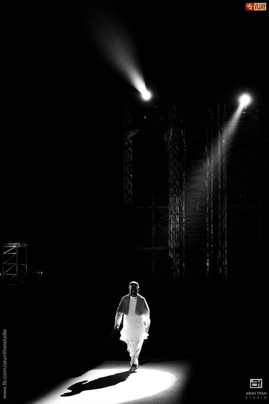 Ilayaraja Walking Through a Dramatic Spotlight in Black and White HD phone wallpaper