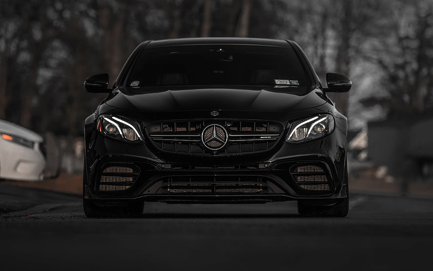 Black Mercedes-Benz E63 AMG W213 Front View on a Dark Road HD wallpaper