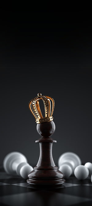 Dark wooden chess king piece with golden crown standing on checkered board HD phone wallpaper