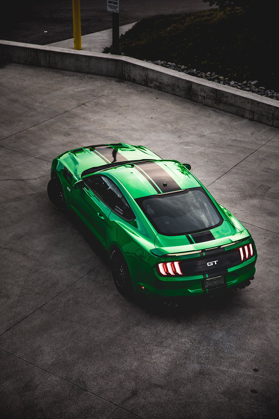 High Angle View of a Vibrant Green Ford Mustang GT with Black Racing Stripes HD phone wallpaper