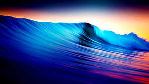 Vibrant Blue Ocean Wave Curling at Sunset with Colorful Sky Reflection HD wallpaper