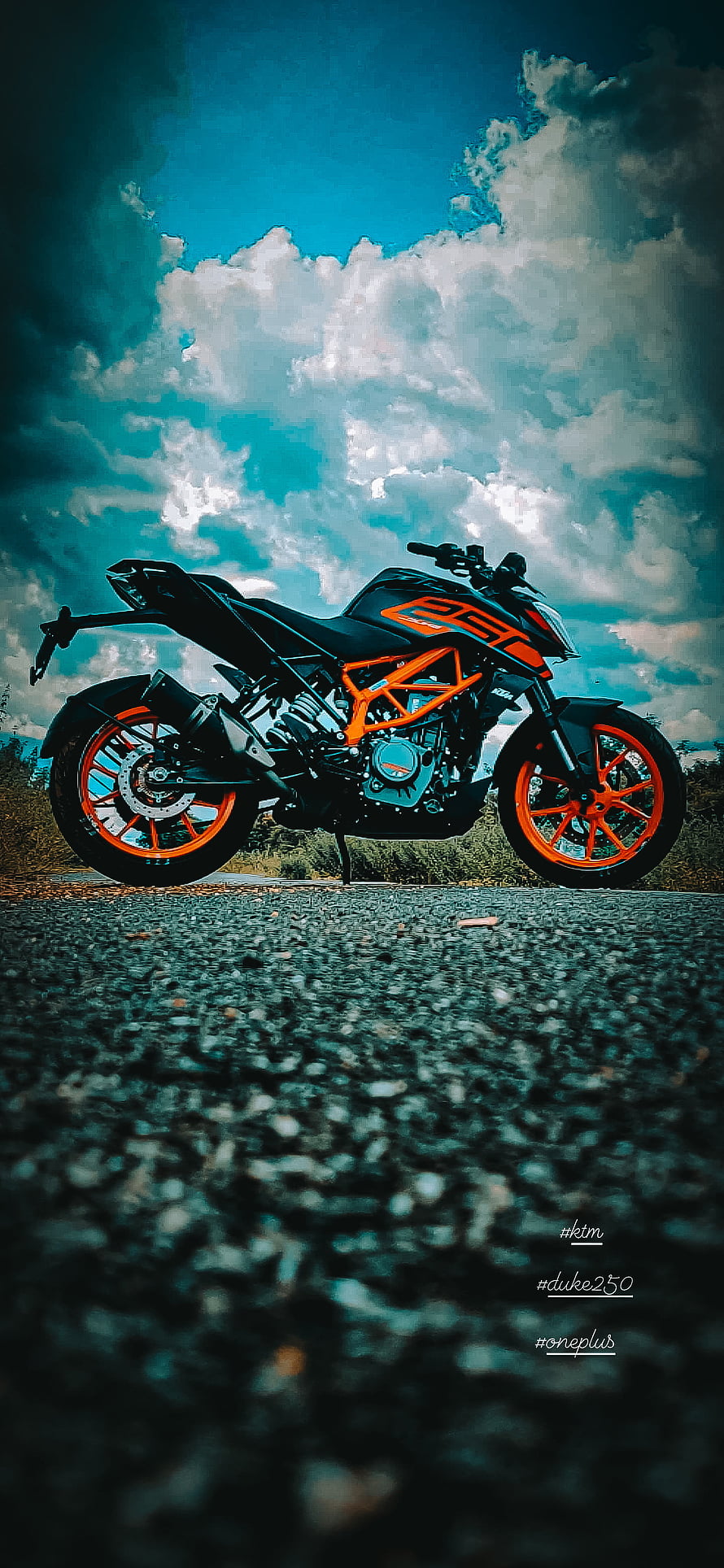 KTM Duke 250 motorcycle with orange frame parked on asphalt road under dramatic blue sky HD phone wallpaper