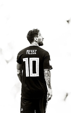 Lionel Messi in Black Away Kit Looking Up in Monochrome Portrait HD phone wallpaper