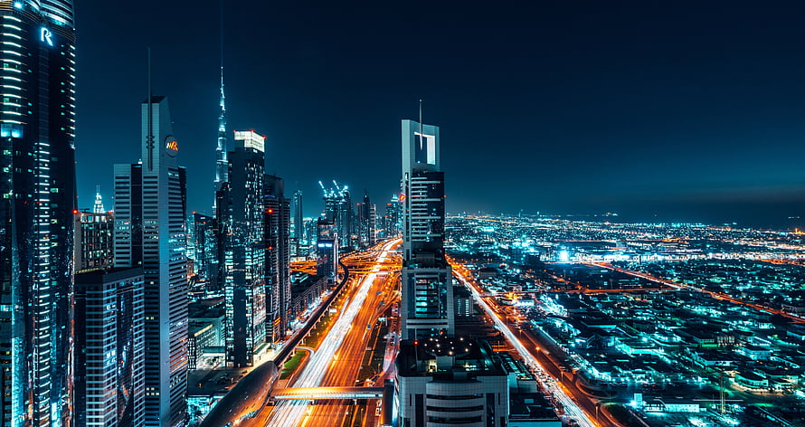 Dubai skyline at night with Sheikh Zayed Road light trails and Burj Khalifa HD wallpaper