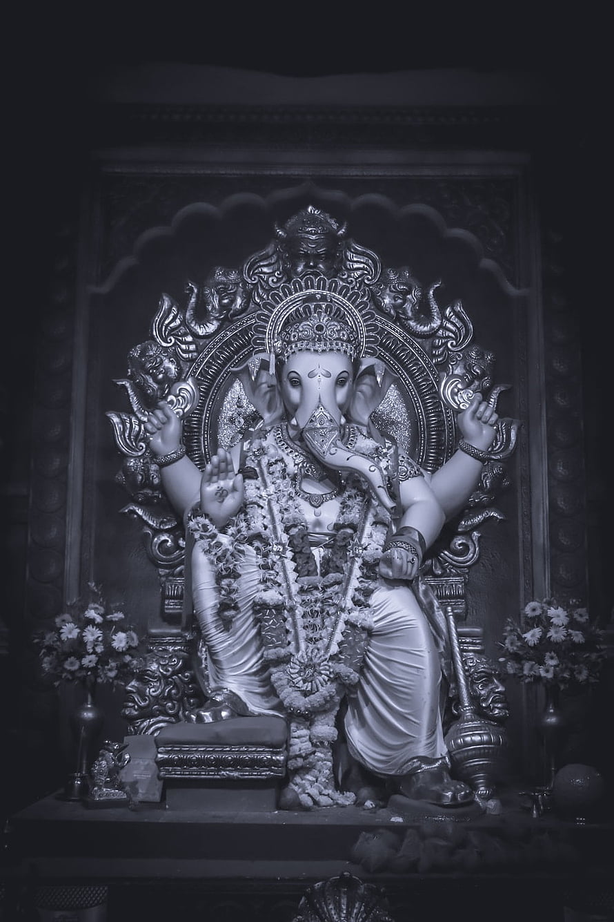 Majestic Black and White Statue of Lord Ganesha Adorned with Floral Garlands HD phone wallpaper