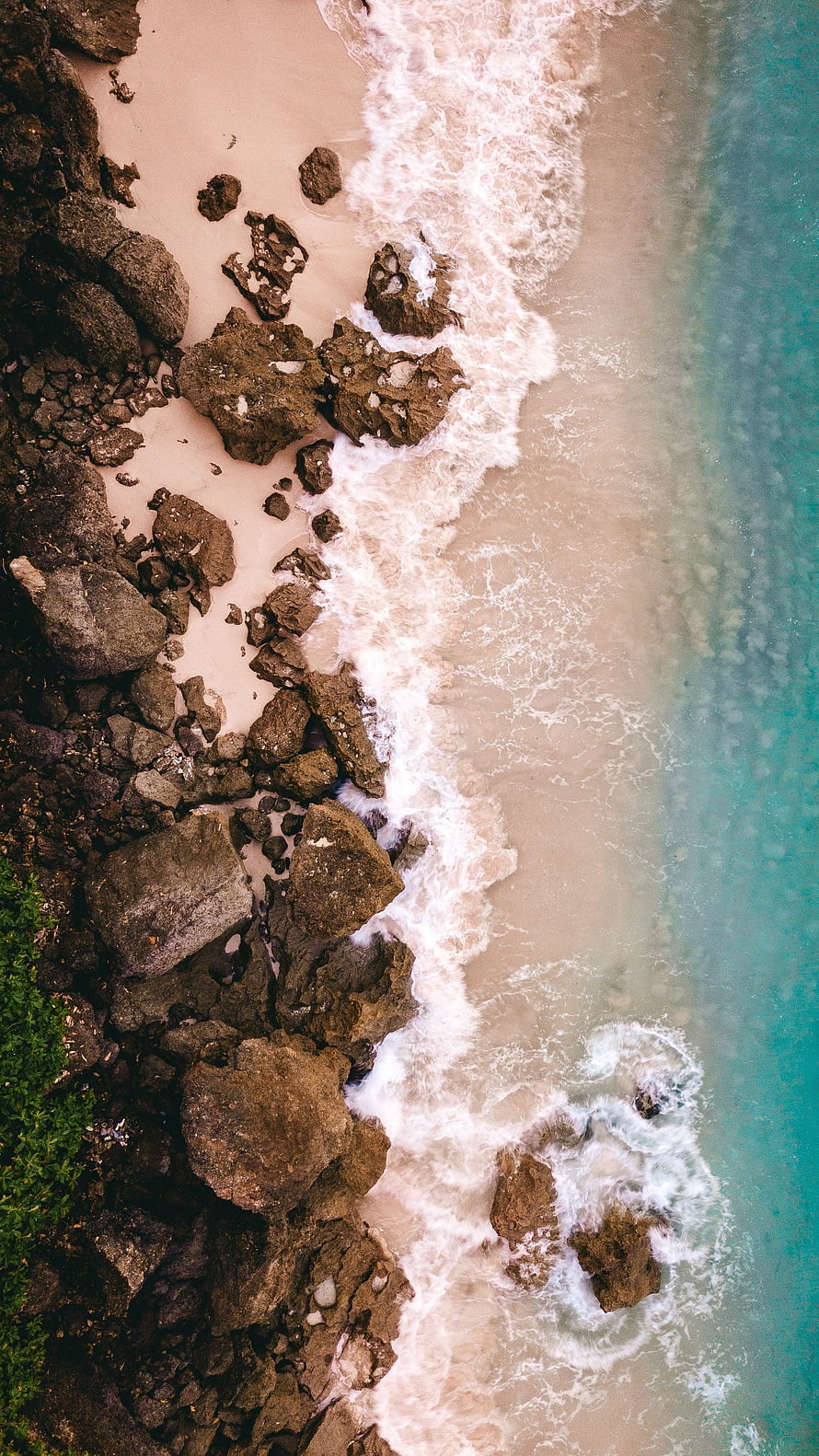 Aerial View of Turquoise Waves Crashing on Rocky Sandy Beach HD phone wallpaper