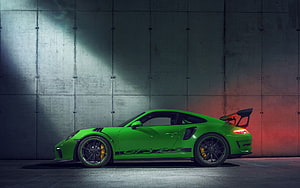 Vibrant Green Porsche 911 GT3 RS Profile Against Industrial Concrete Wall HD wallpaper
