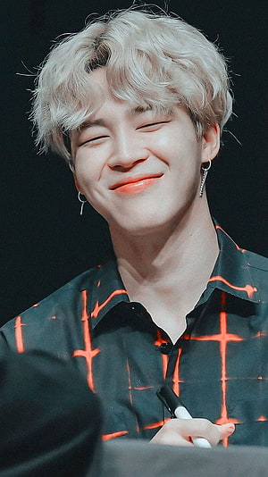 Park Jimin from BTS smiling with platinum blonde hair and orange cross-pattern shirt HD phone wallpaper