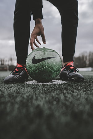 Soccer Player Placing Green Nike Ball on Artificial Turf Field HD phone wallpaper