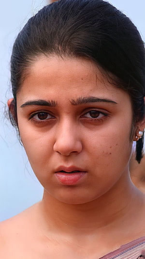 Mesmerizing Close-Up Portrait of a Woman with Intense Gaze and Dark Hair, Charmi Kaur, telugu actress HD phone wallpaper