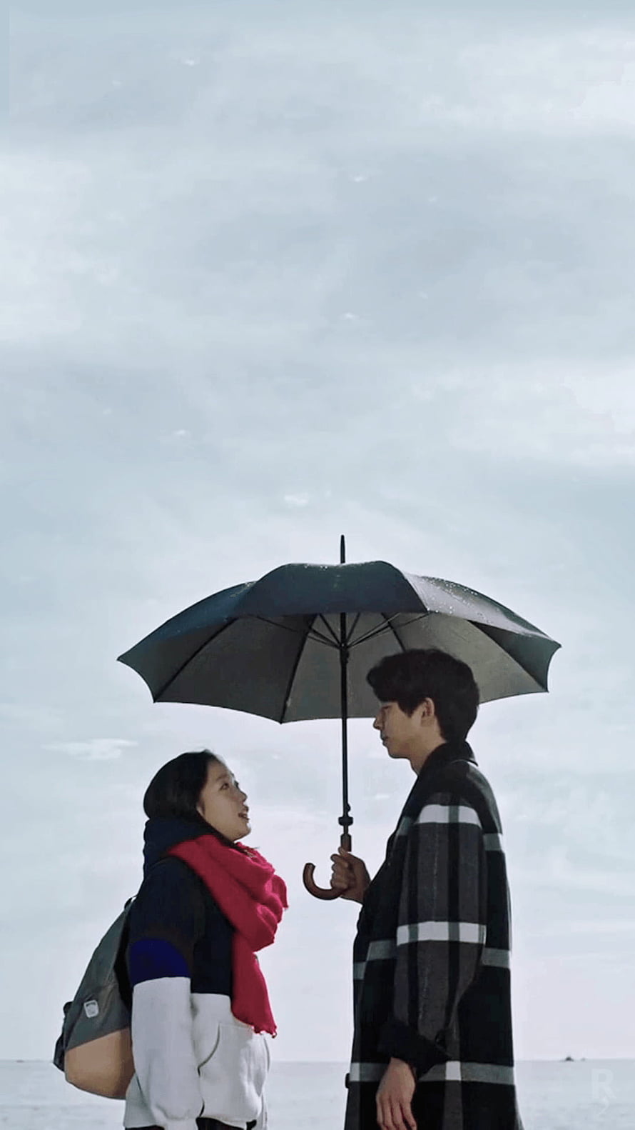 Gong Yoo and Kim Go Eun share a tender moment under a black umbrella in the Korean drama Goblin HD phone wallpaper
