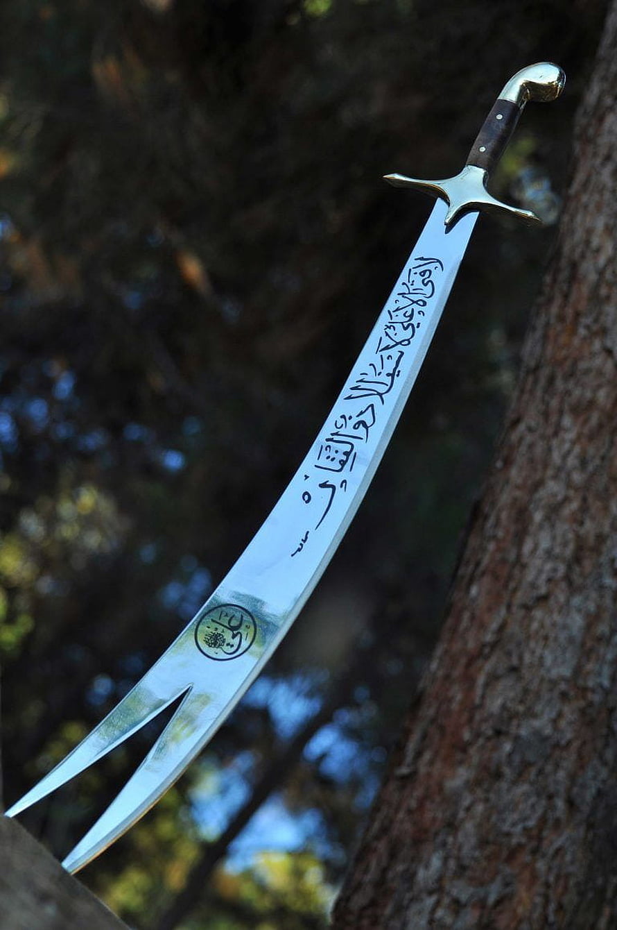 Ornate Scimitar Sword With Arabic Calligraphy Etched On Blade Resting Against Tree HD phone wallpaper