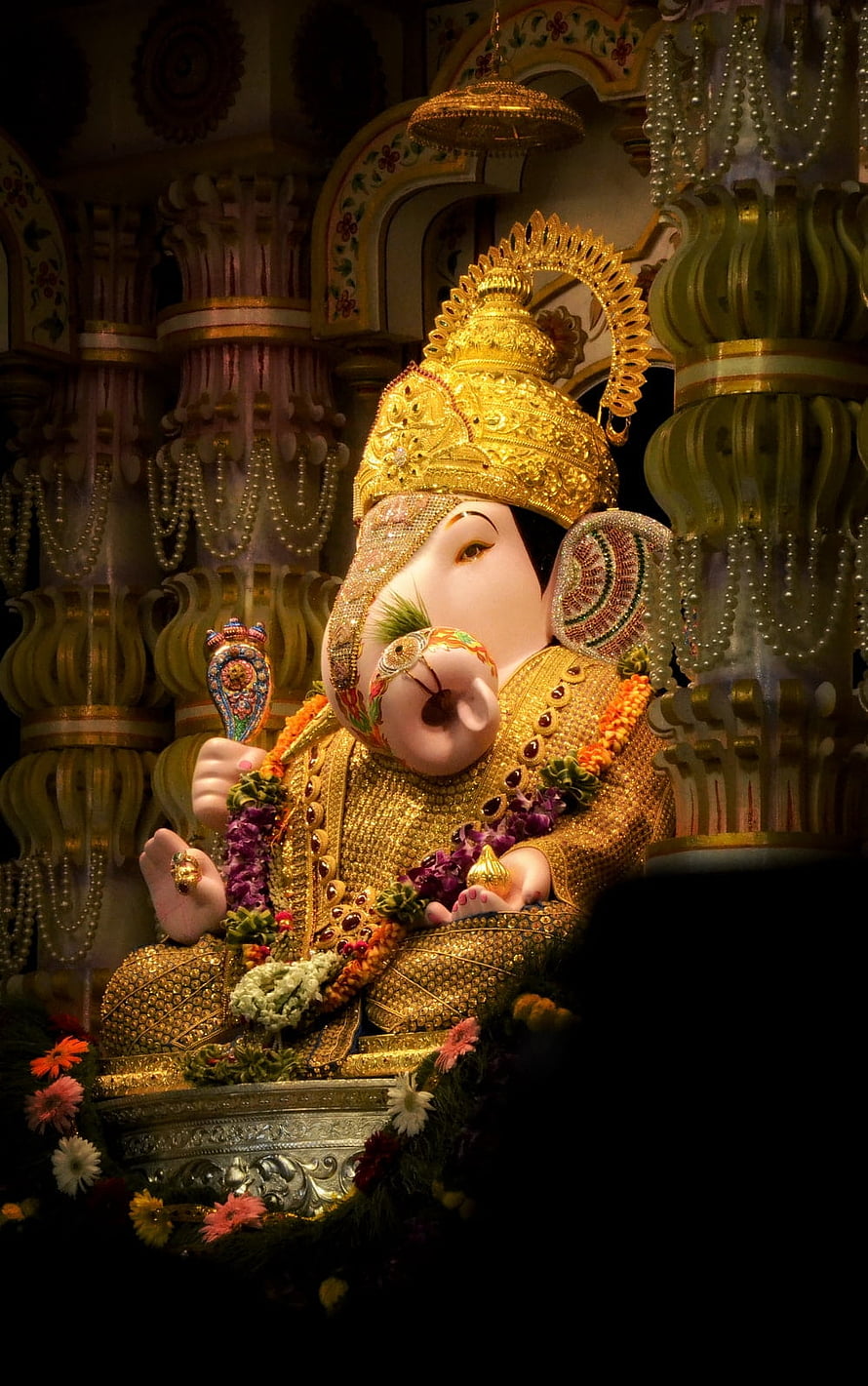Golden Ganesha Idol Adorned with Jewels and Flowers in Temple HD phone wallpaper