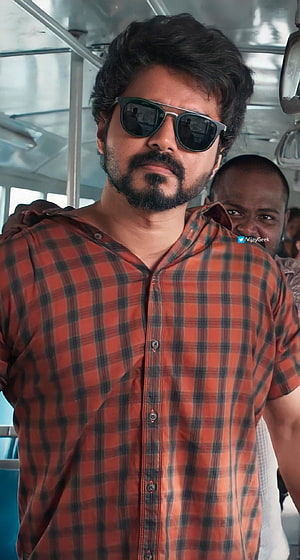 Dhanush in a red plaid shirt and sunglasses on a bus set HD phone wallpaper