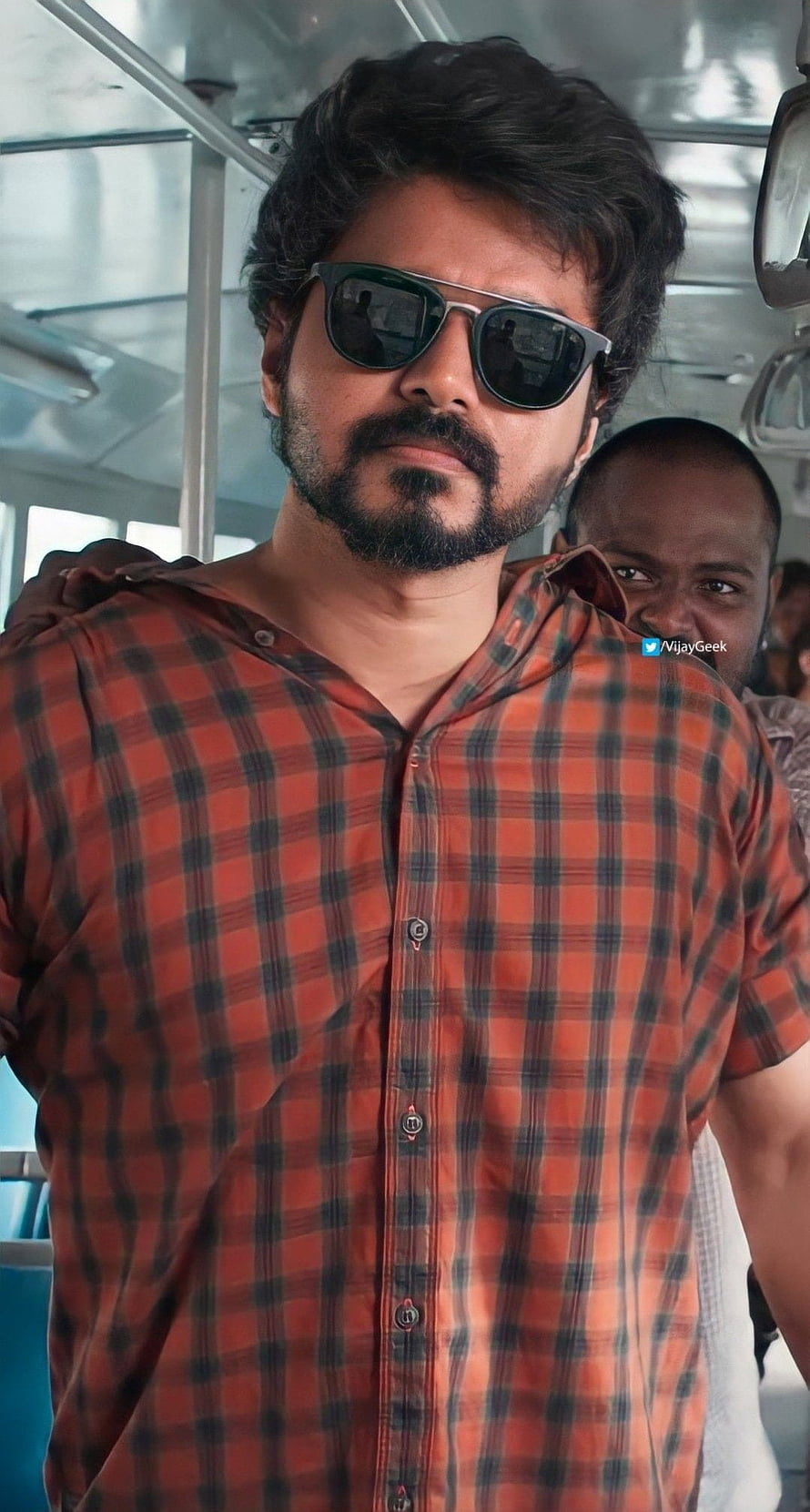Dhanush in a red plaid shirt and sunglasses on a bus set HD phone wallpaper