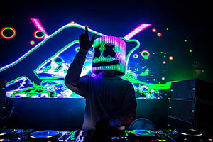 Marshmello DJ performing live concert with neon LED helmet and colorful stage lights HD wallpaper