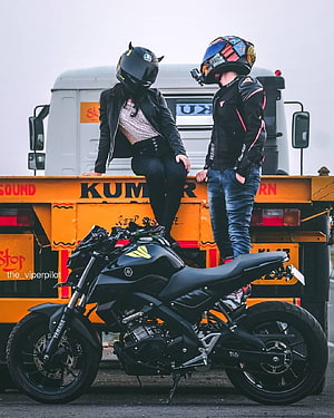 Couple in Motorcycle Gear Posing with Black Yamaha MT-15 Near Orange Tow Truck HD phone wallpaper