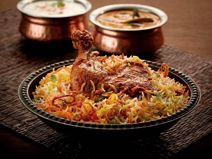 Authentic Chicken Biryani with Raita and Curry in Traditional Copper Bowls HD wallpaper