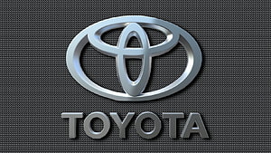 Sleek Silver Toyota Emblem on Dark Textured Carbon Fiber Background HD wallpaper