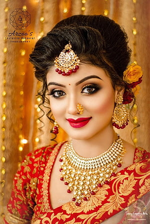 Elegant Indian Bride in Red Saree with Traditional Gold Jewelry and Floral Hair Accessories HD phone wallpaper