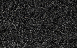 Close-up of dark asphalt road surface with coarse aggregate texture HD wallpaper