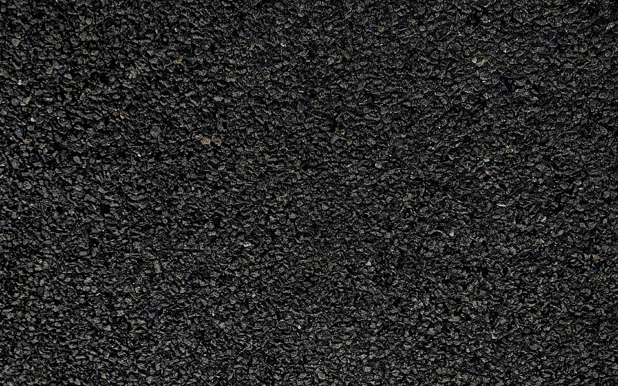 Close-up of dark asphalt road surface with coarse aggregate texture HD wallpaper