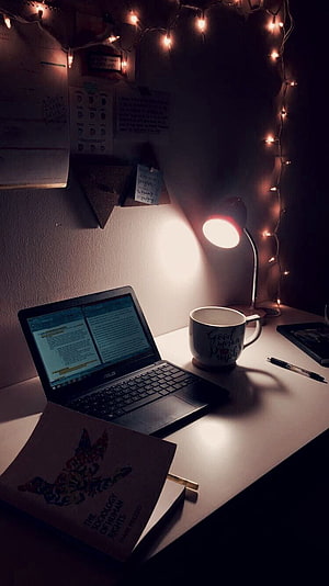 Cozy Night Study Setup with Laptop, Books, and Warm Fairy Lights HD phone wallpaper