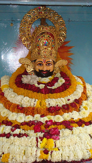 Decorated Statue of Lord Ayyappa with Flower Garland and Golden Crown HD phone wallpaper