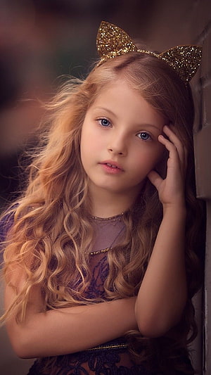 Portrait of a young girl with long wavy blonde hair wearing a glittery gold cat ear headband HD phone wallpaper