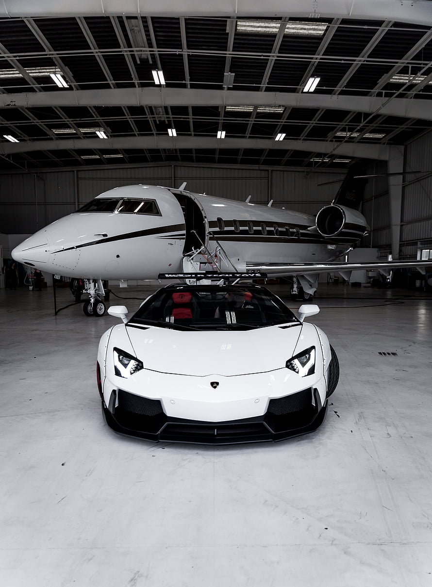 White Lamborghini Aventador and Private Jet in Hangar HD phone wallpaper