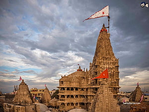 Ancient Khajuraho Temple Complex with Intricate Stone Carvings and Flags HD wallpaper