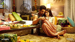 Hrithik Roshan and Kiara Advani in an intimate moment from the movie Sanam Re, surrounded by festive decorations and gifts HD wallpaper