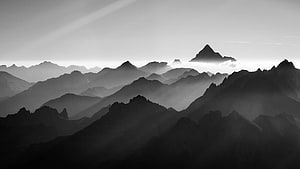 Misty Mountain Ranges in Black and White with Atmospheric Depth HD wallpaper
