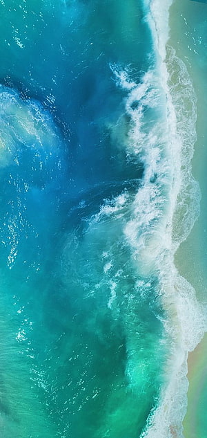 Aerial View of Turquoise Ocean Waves Rolling onto Sandy Shore HD phone wallpaper