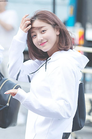 Jihyo from Twice in a white hoodie with a soft smile and casual street style HD phone wallpaper