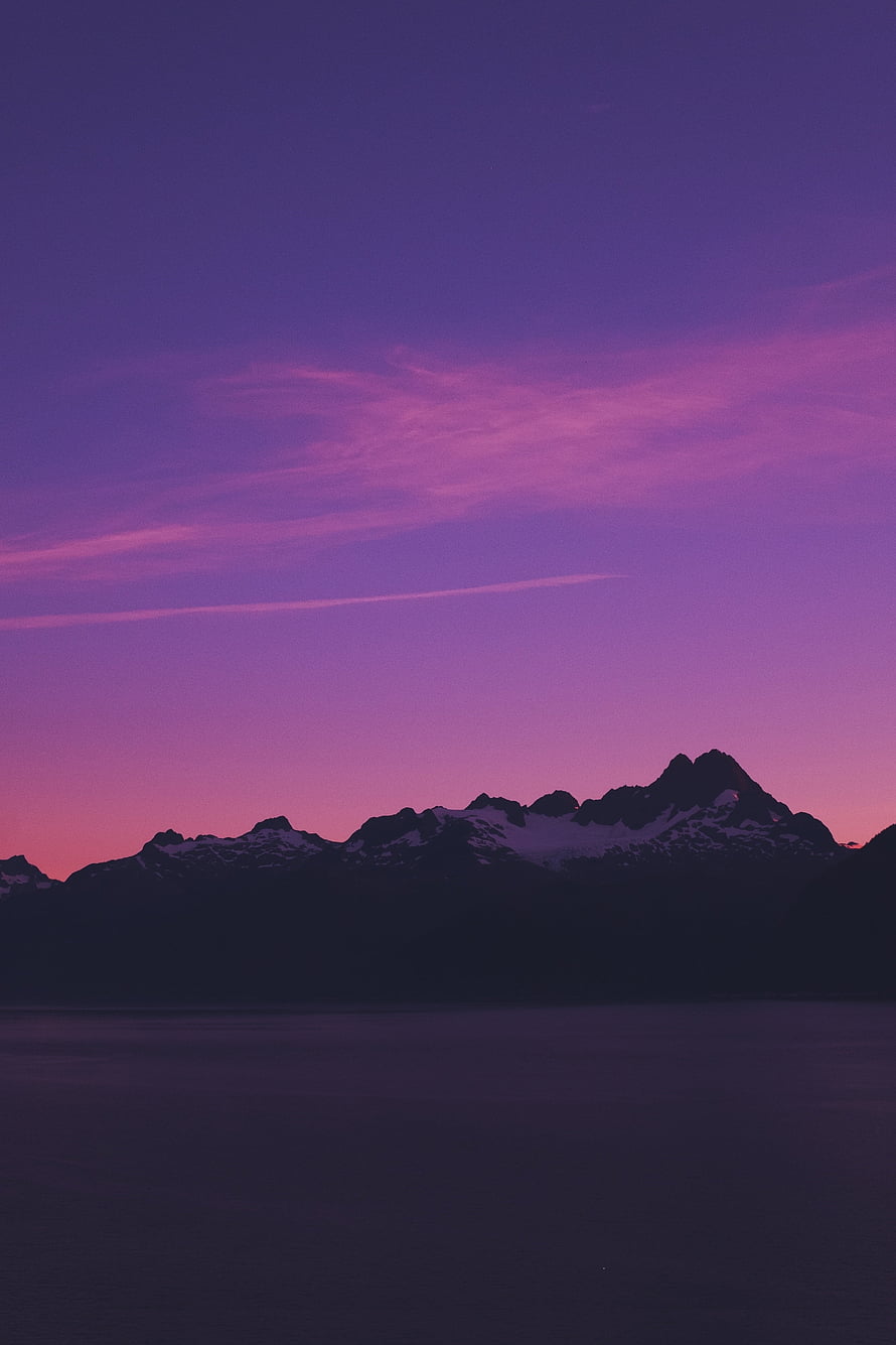 Purple Sunset Over Snow-Capped Mountains And Calm Water HD phone wallpaper