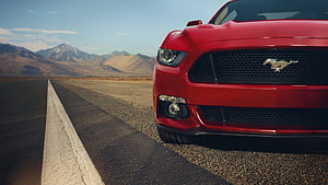 Red Ford Mustang GT Front Grille on Desert Highway with Mountain Backdrop HD wallpaper