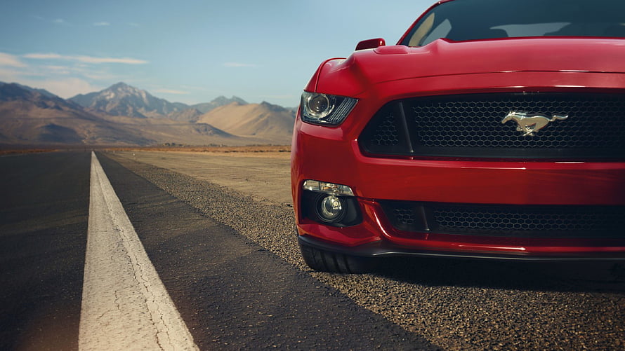 Red Ford Mustang GT Front Grille on Desert Highway with Mountain Backdrop HD wallpaper