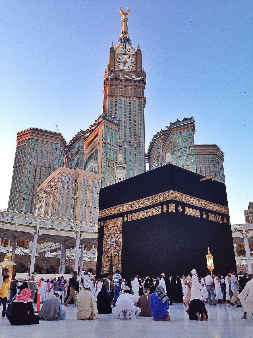 Kaaba in Mecca with Abraj Al Bait Clock Tower and Pilgrims Praying HD phone wallpaper
