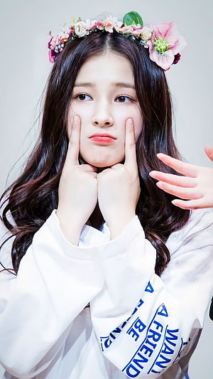 Nancy from Momoland wearing a floral crown and white sweatshirt posing with fingers on cheeks HD phone wallpaper