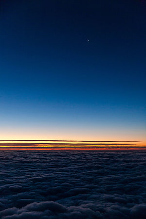 Aerial View of Sunset Horizon Above a Vast Sea of Clouds HD phone wallpaper