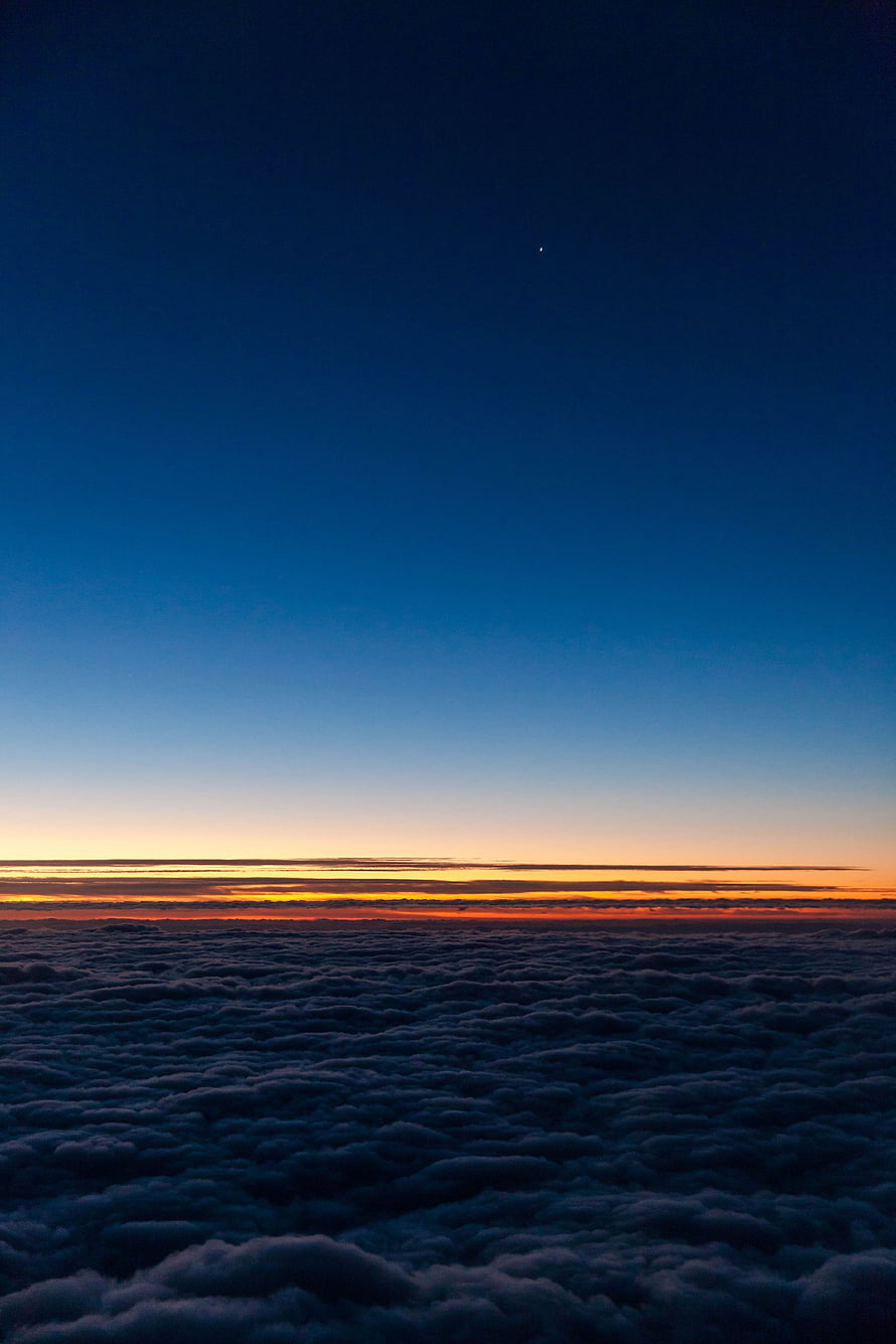 Aerial View of Sunset Horizon Above a Vast Sea of Clouds HD phone wallpaper