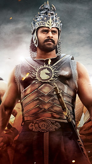 Prabhas as Baahubali in ornate warrior armor and spiked crown from the epic film HD phone wallpaper