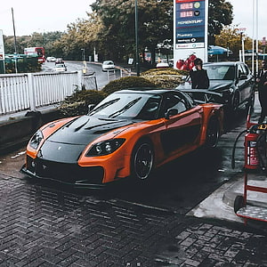 Orange Mazda RX-7 Veilside Widebody at a Gas Station HD phone wallpaper