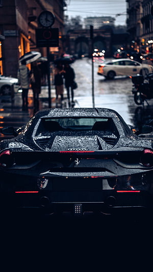 Rear View of a Black Ferrari 488 GTB Parked on a Rainy City Street HD phone wallpaper