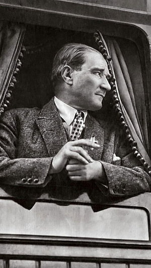 Mustafa Kemal Ataturk in a tweed suit holding a cigarette in a vintage black and white portrait HD phone wallpaper